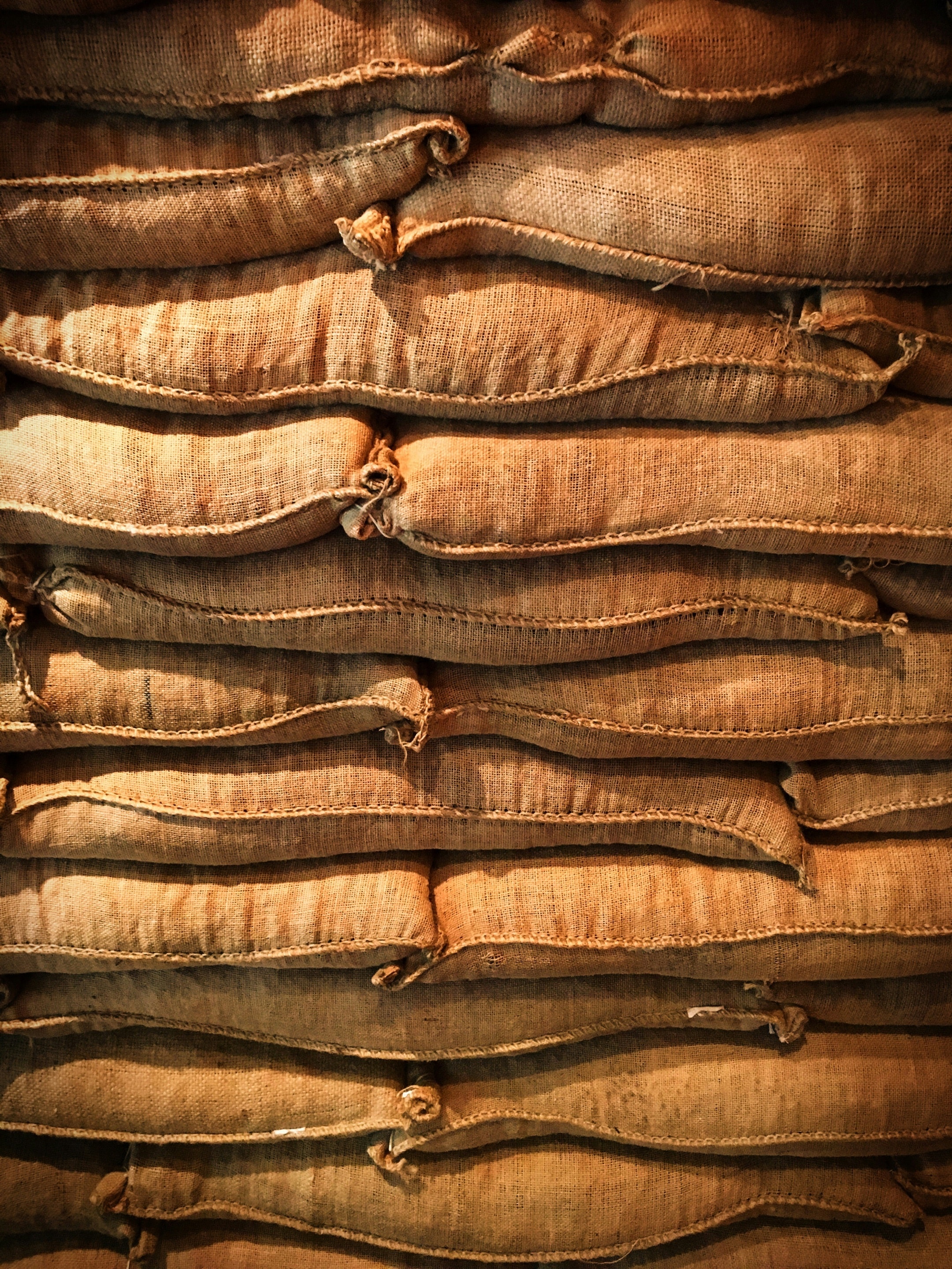 Stacked burlap coffee sacks at Brana Roastery